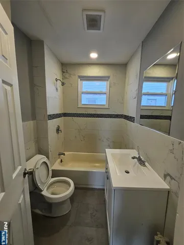 a bathroom with a sink a toilet and bathtub