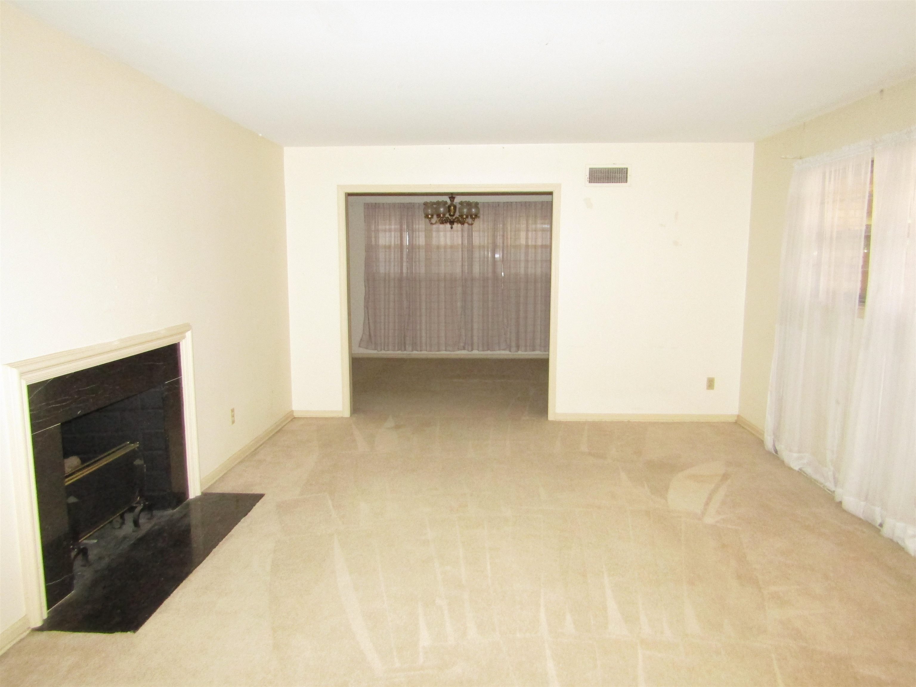 244 South Grove Park Road Memphis, TN 38117 - Photo 6 of 16 a view of an empty room with cabinet and a fireplace