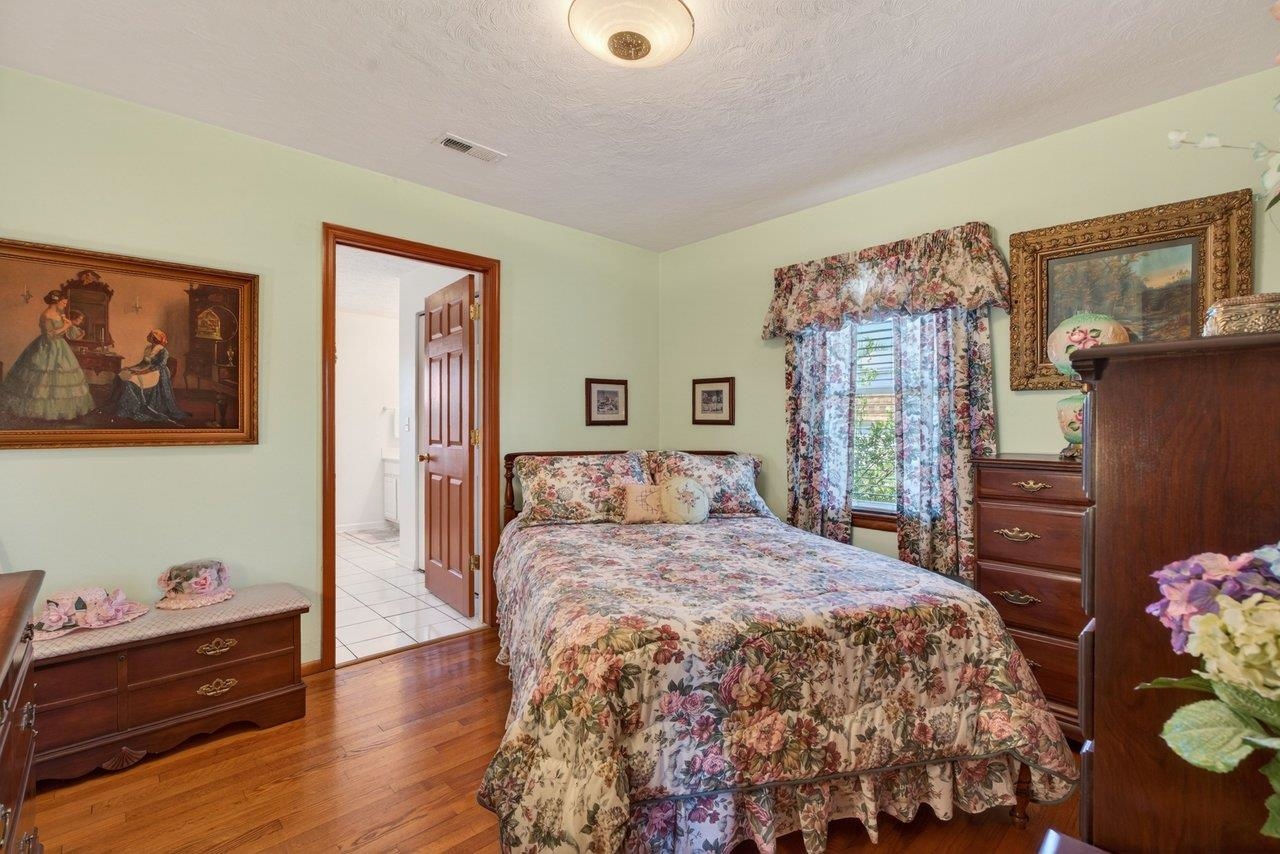 9625 Town Hall Road McGaheysville, VA 22840 - Photo 27 of 65 a bedroom with a bed and dresser with mirror