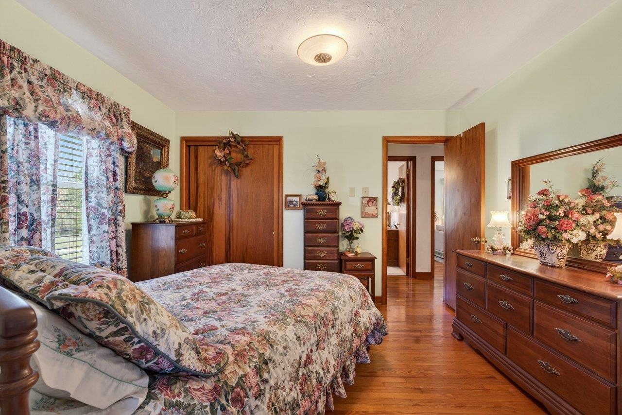 9625 Town Hall Road McGaheysville, VA 22840 - Photo 29 of 65 a bedroom with a large bed and dresser with mirror