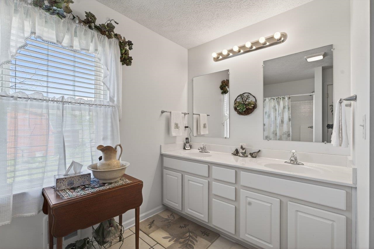9625 Town Hall Road McGaheysville, VA 22840 - Photo 30 of 65 a bathroom with a double vanity sink and a mirror
