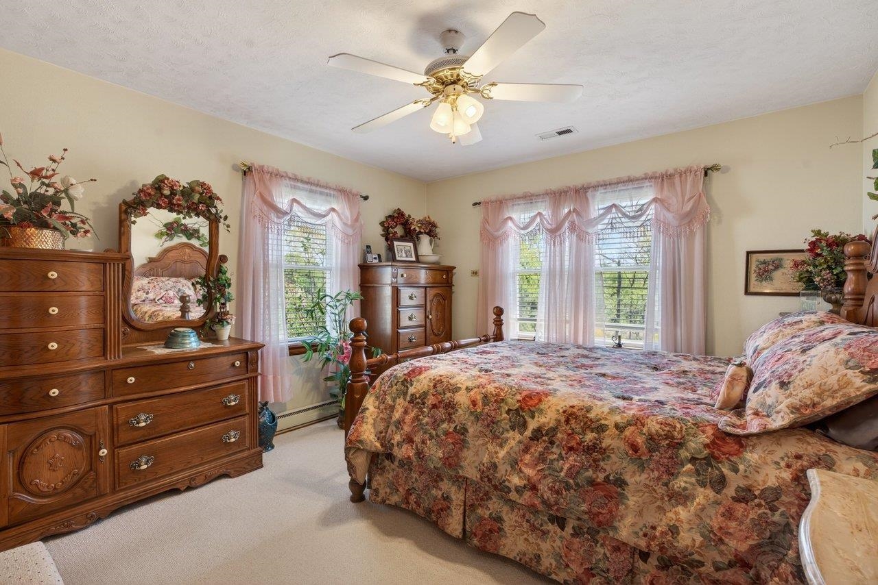 9625 Town Hall Road McGaheysville, VA 22840 - Photo 33 of 65 a bed sitting in a bedroom next to a window and a dresser