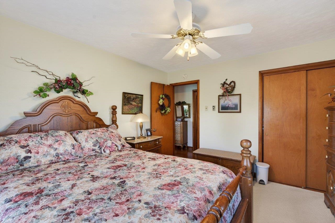 9625 Town Hall Road McGaheysville, VA 22840 - Photo 34 of 65 a bedroom with a bed and a chandelier