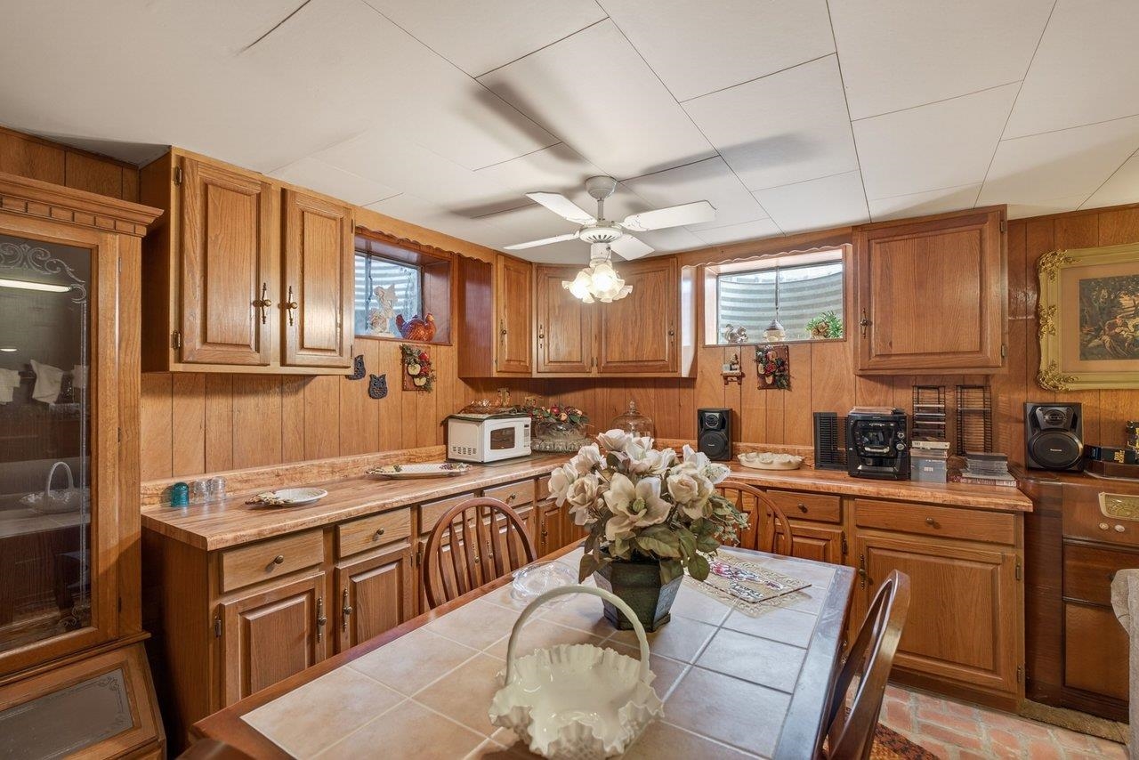 9625 Town Hall Road McGaheysville, VA 22840 - Photo 41 of 65 a kitchen with stainless steel appliances granite countertop a sink dishwasher stove refrigerator dining table and chairs