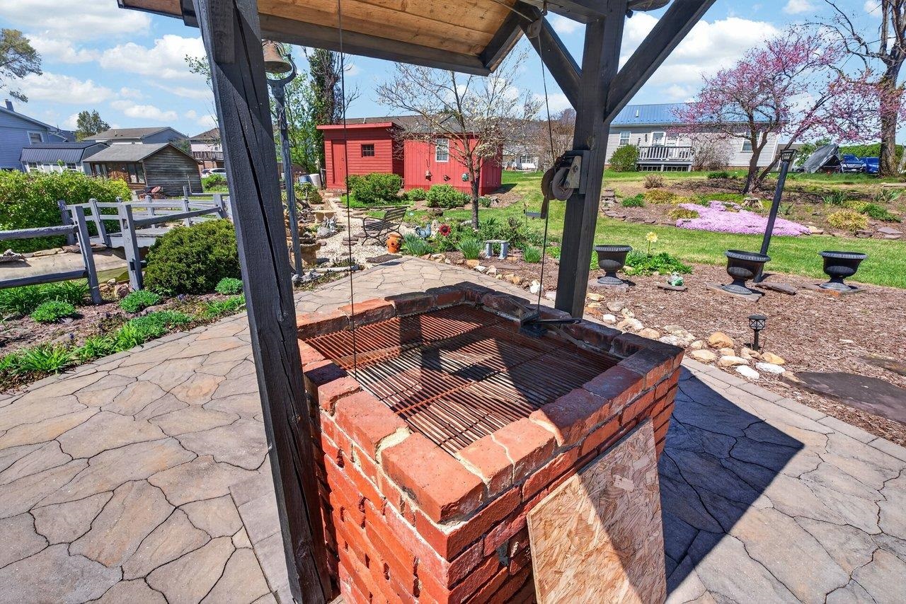 9625 Town Hall Road McGaheysville, VA 22840 - Photo 60 of 65 a view of a patio with table and chairs potted plants and large tree