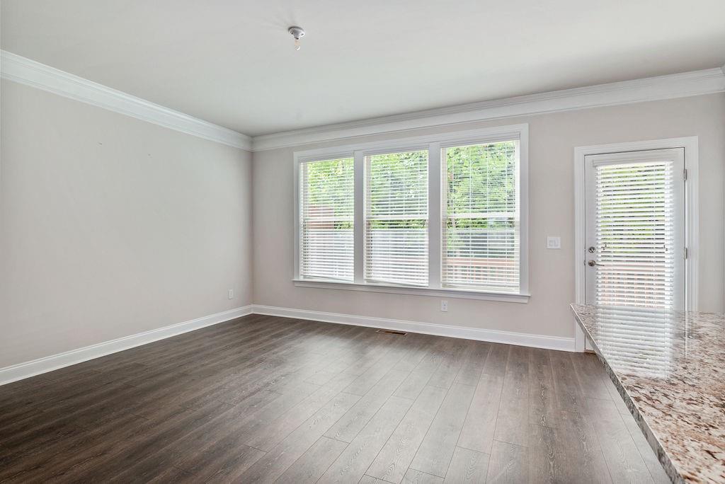 1395 Harris Way Street Brookhaven, GA 30319 - Photo 11 of 28 a view of an empty room with wooden floor and a window