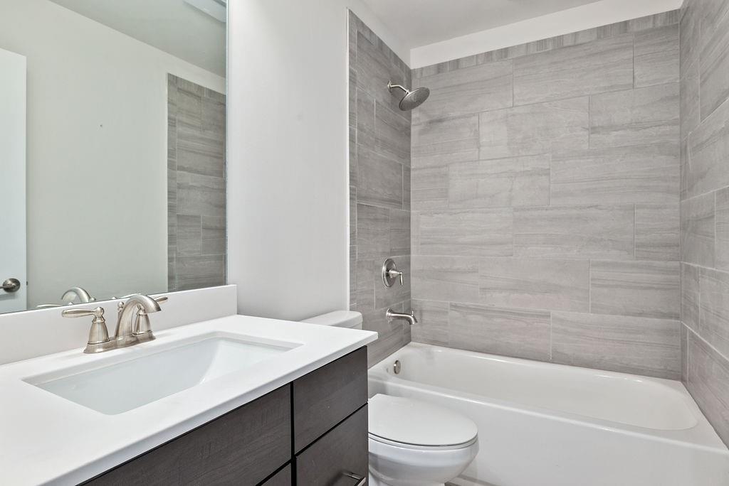 1395 Harris Way Street Brookhaven, GA 30319 - Photo 21 of 28 a bathroom with a granite countertop sink toilet and bathtub