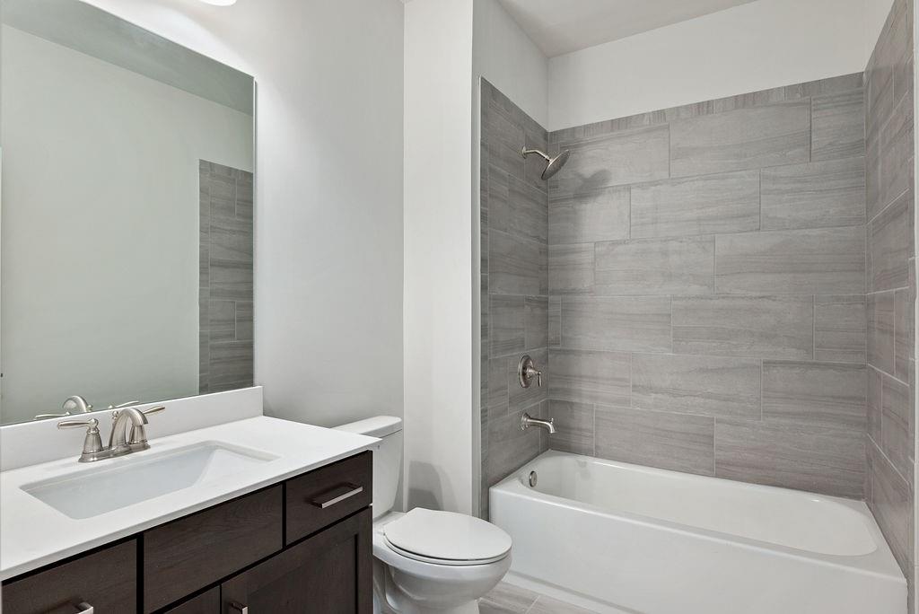 1395 Harris Way Street Brookhaven, GA 30319 - Photo 24 of 28 a bathroom with a bathtub shower sink mirror vanity and toilet