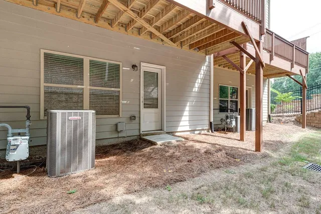 a balcony with wooden floor and trees in the background