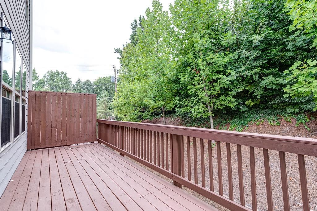 1395 Harris Way Street Brookhaven, GA 30319 - Photo 26 of 28 a balcony with wooden floor and trees in the background