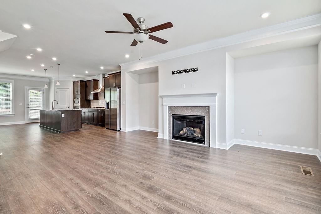 1395 Harris Way Street Brookhaven, GA 30319 - Photo 4 of 28 a view of a livingroom with a fireplace a ceiling fan and windows