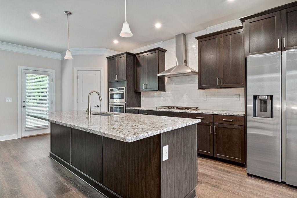 1395 Harris Way Street Brookhaven, GA 30319 - Photo 7 of 28 a kitchen with stainless steel appliances granite countertop a sink stove and refrigerator
