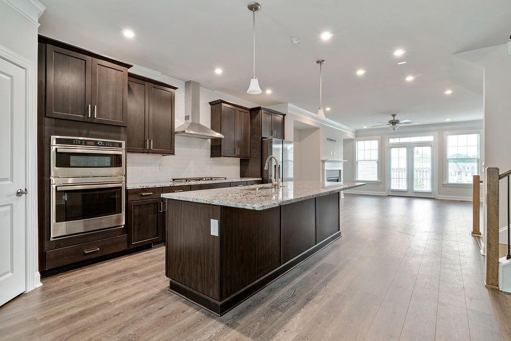 1395 Harris Way Street Brookhaven, GA 30319 - Photo 8 of 28 a kitchen with stainless steel appliances granite countertop a stove a sink and a refrigerator
