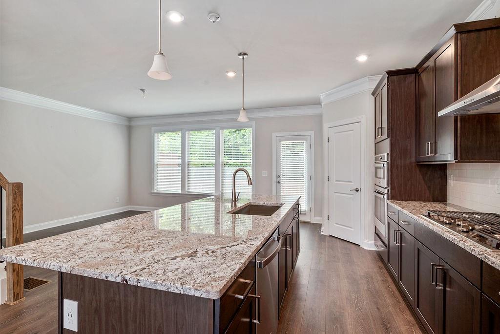1395 Harris Way Street Brookhaven, GA 30319 - Photo 10 of 28 a kitchen with stainless steel appliances granite countertop a stove top oven a sink dishwasher and a refrigerator with wooden floor