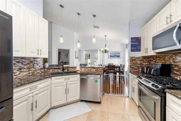 a kitchen with lots of counter top space appliances and a sink