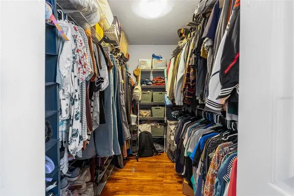 a view of walk in closet with clothes