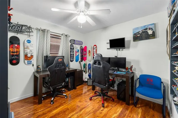 a view of a workspace with furniture and a window