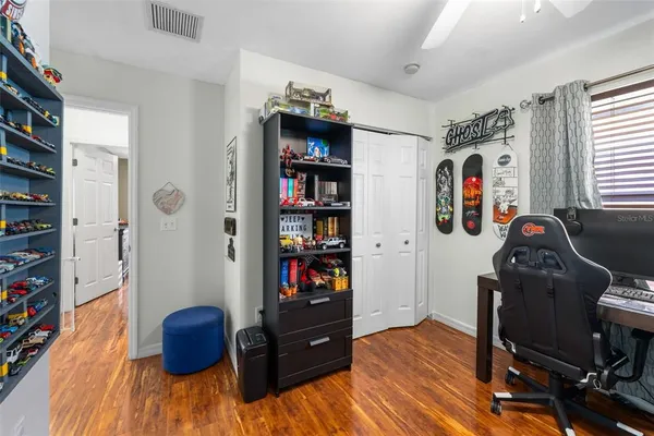 a view of a workspace with furniture and book shelf