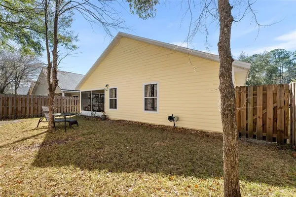 a backyard of a house with table and chairs