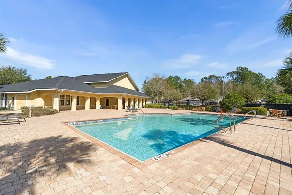 a view of a house with swimming pool and a yard