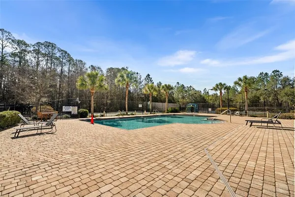 a view of a swimming pool with a patio