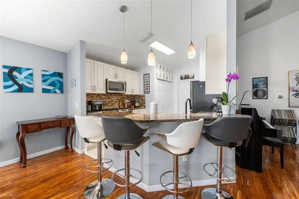 a view of a dining room with furniture and wooden floor
