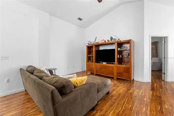 a living room with furniture and a wooden floor