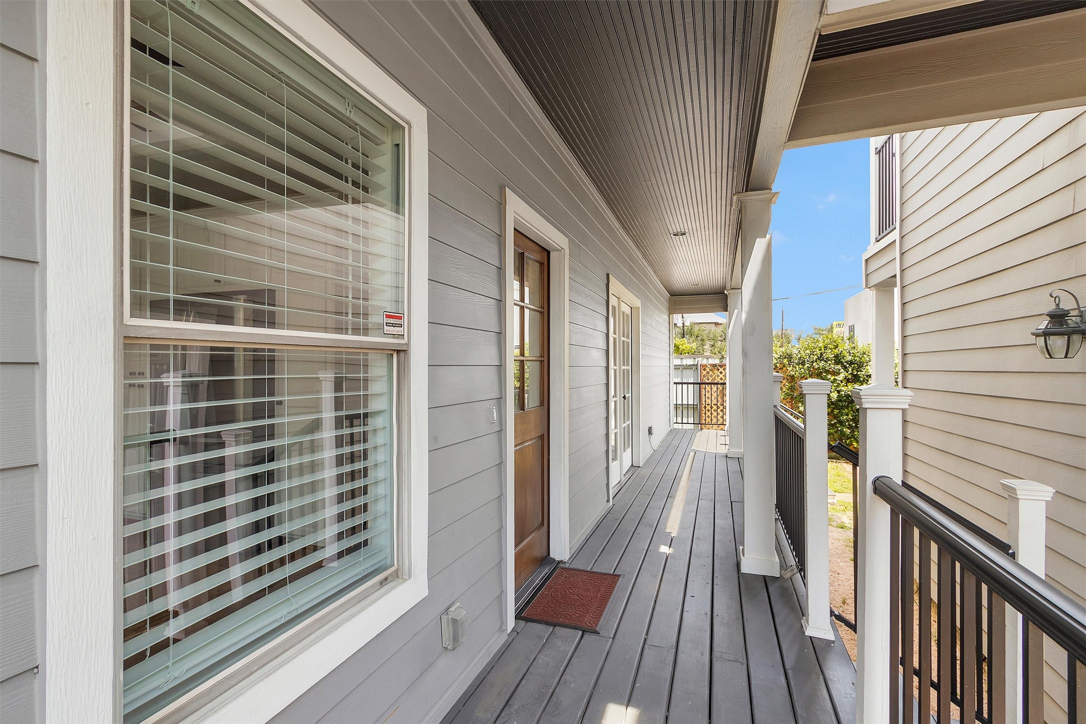 304 Vincent Street Houston, TX 77009 - Photo 30 of 36 a view of a balcony with wooden floor and floor to ceiling window