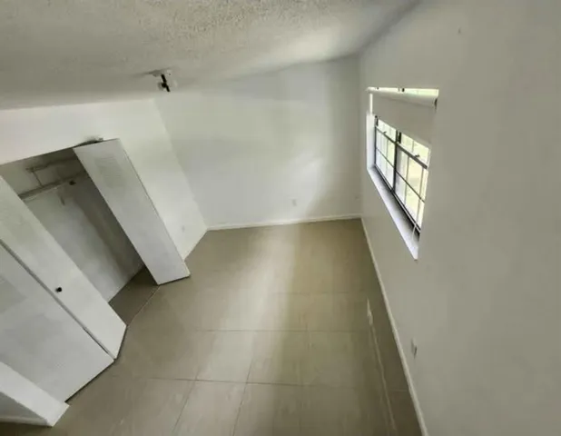 a view of a hallway to rooms