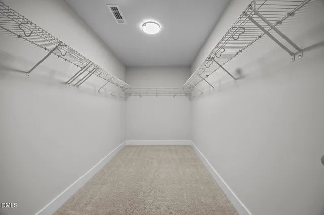 a dining room with wooden floor a chandelier a wooden table and chairs