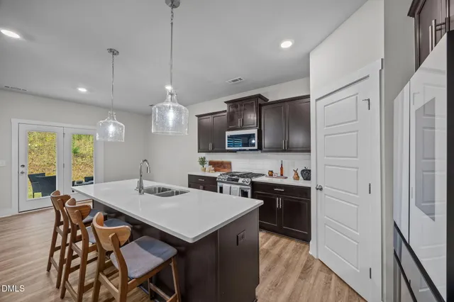 a kitchen with stainless steel appliances granite countertop sink stove and cabinets