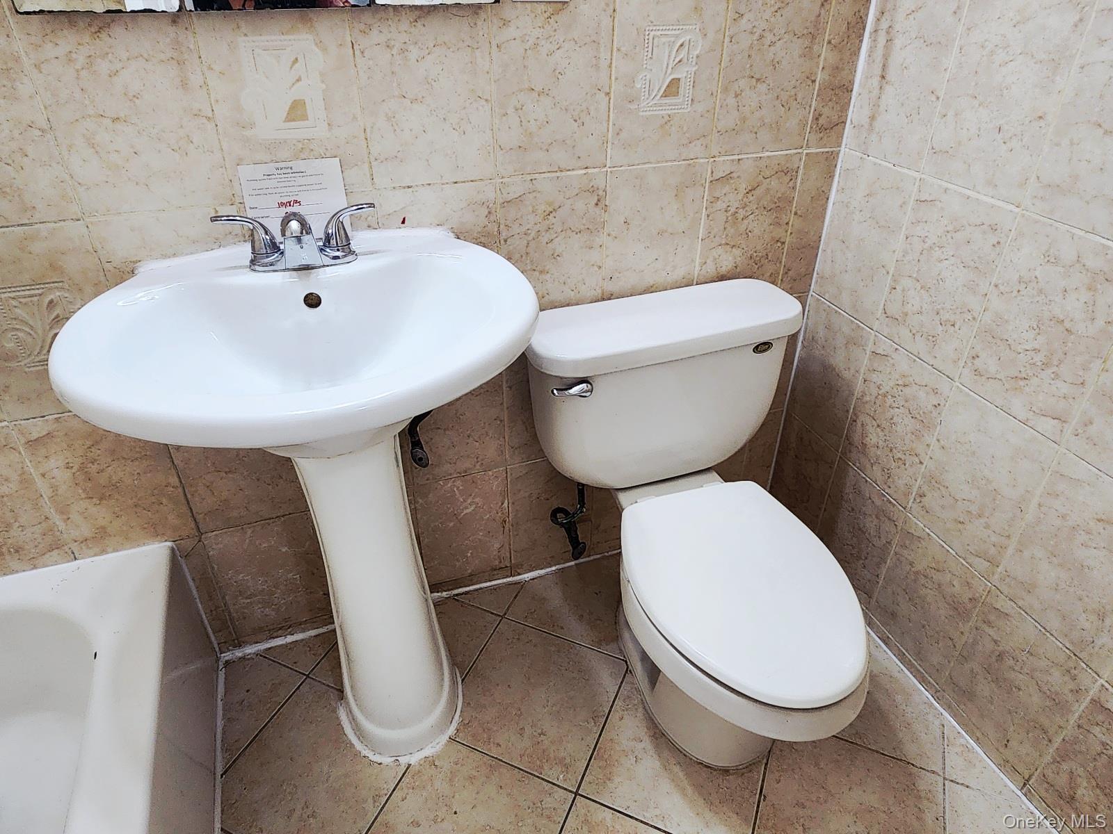 112 Union Road, Unit 3L Spring Valley, NY 10977 - Photo 16 of 19 a white toilet sitting next to a white sink