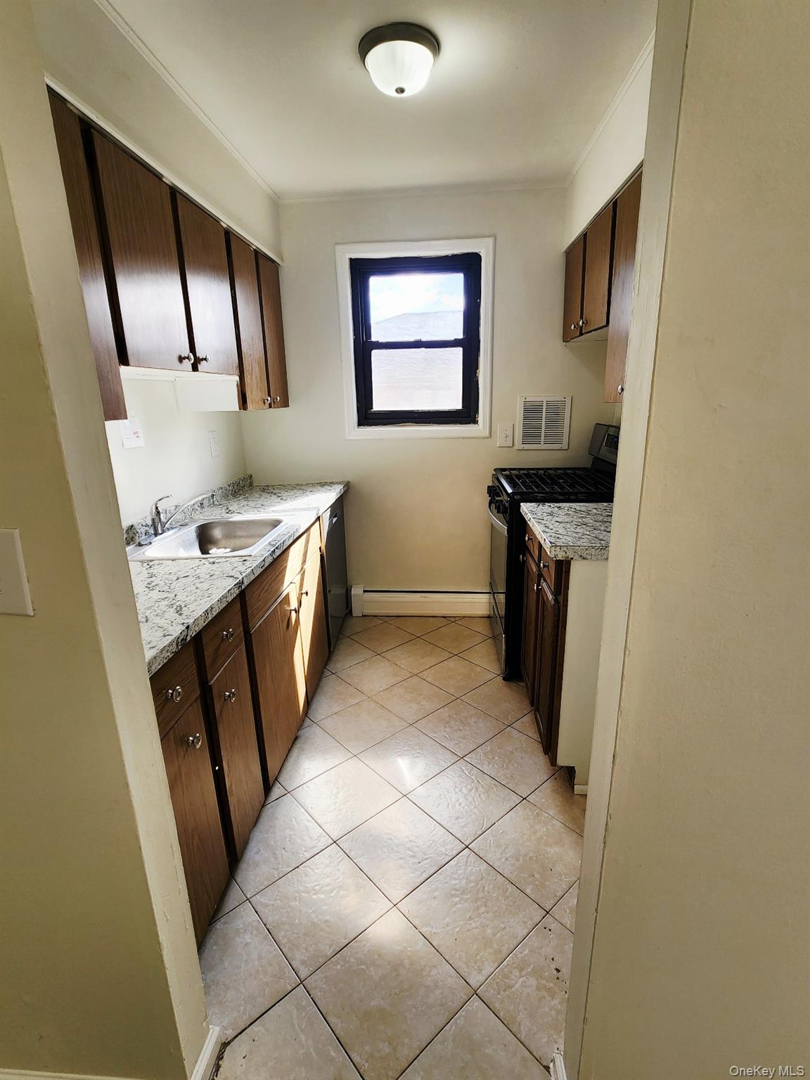 112 Union Road, Unit 3L Spring Valley, NY 10977 - Photo 8 of 19 a kitchen with stainless steel appliances granite countertop a stove a sink and a refrigerator