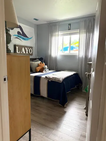 a bedroom with furniture and a flat screen tv