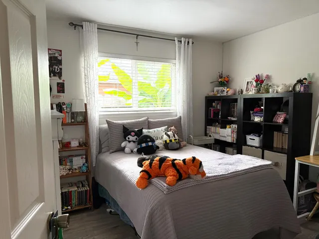 a bedroom with a bed and a window