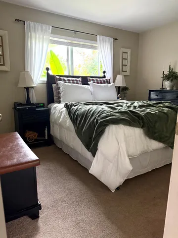 a white toilet sitting next to a bathroom sink and a shower