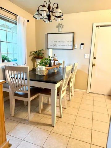 a table with a vase and flowers on it
