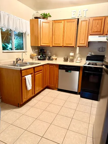 a living room with furniture a rug and white walls