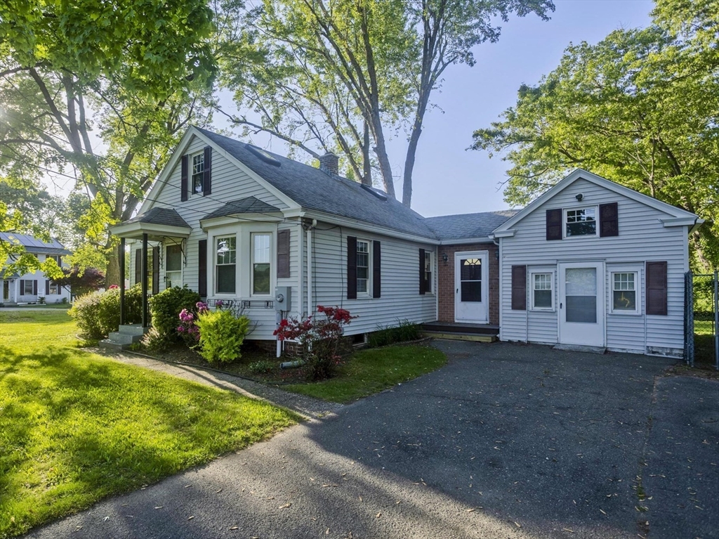 1350 Wilbraham Road Springfield, MA 01119 - Photo 1 of 35 a front view of a house with a garden and porch