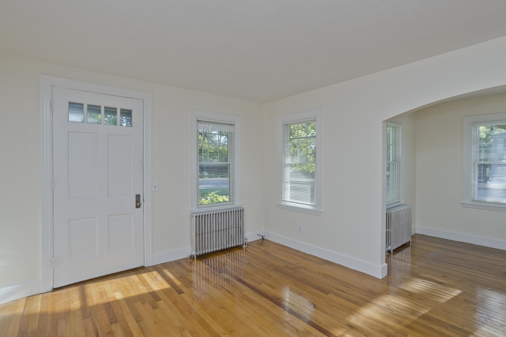 1350 Wilbraham Road Springfield, MA 01119 - Photo 12 of 35 a view of an empty room with window and wooden floor