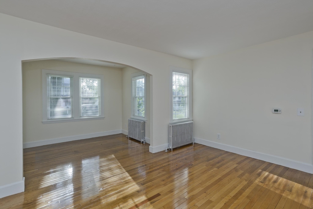 1350 Wilbraham Road Springfield, MA 01119 - Photo 14 of 35 a view of an empty room with wooden floor and a window