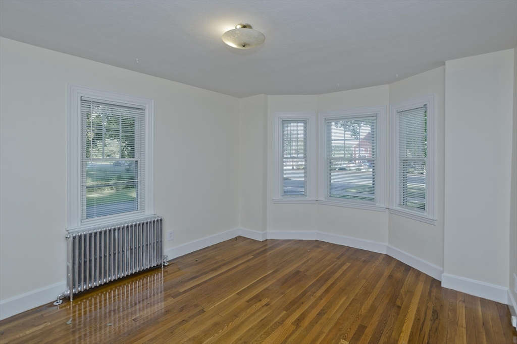 1350 Wilbraham Road Springfield, MA 01119 - Photo 17 of 35 an empty room with wooden floor and windows