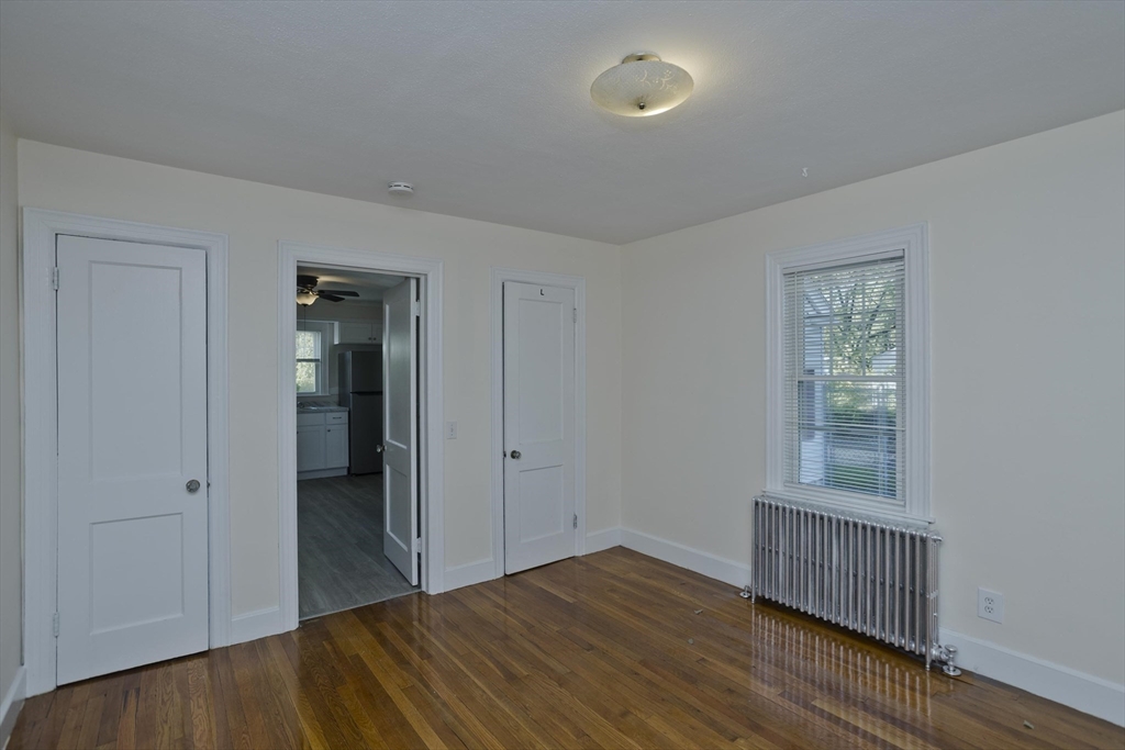1350 Wilbraham Road Springfield, MA 01119 - Photo 19 of 35 a view of an empty room with wooden floor and a window