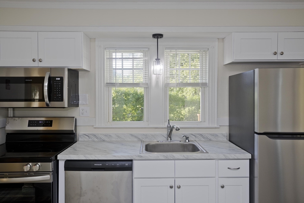 1350 Wilbraham Road Springfield, MA 01119 - Photo 6 of 35 a kitchen with appliances a sink and a window