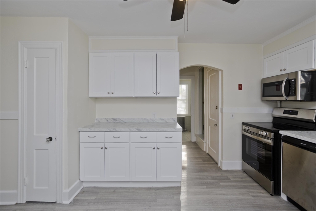 1350 Wilbraham Road Springfield, MA 01119 - Photo 7 of 35 a kitchen with stainless steel appliances granite countertop a refrigerator and a stove top oven