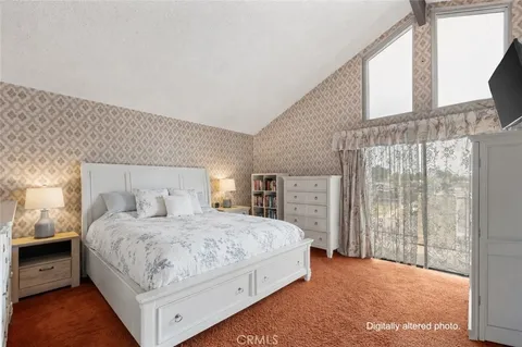 a spacious bedroom with a bed and a chandelier