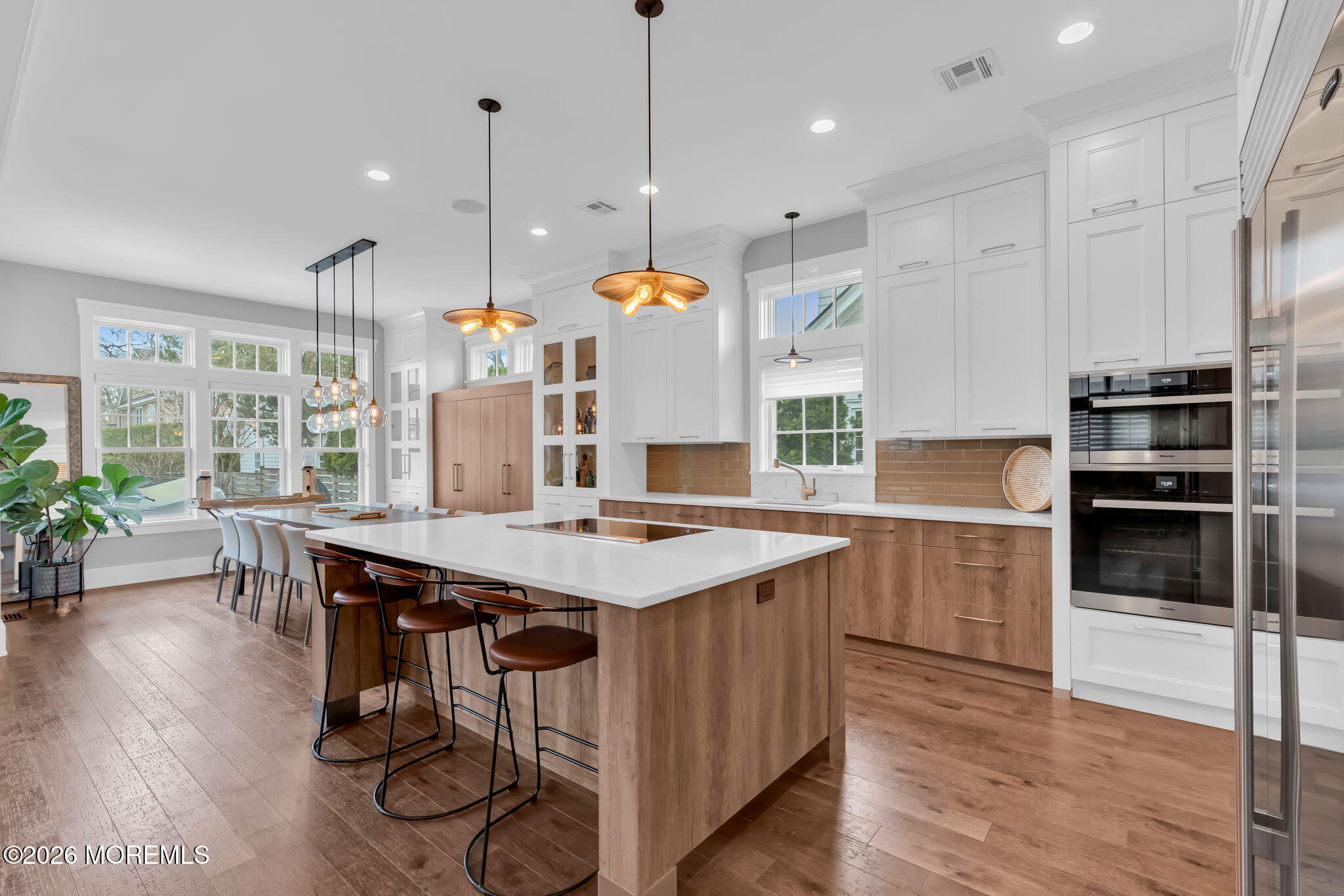 218 Worthington Avenue Spring Lake, NJ 07762 - Photo 11 of 51 a kitchen with a table chairs stainless steel appliances and wooden floor