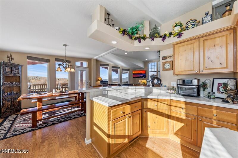 231 Atcheson Yerington, NV 89447 - Photo 12 of 30 a kitchen with stainless steel appliances granite countertop a sink stove and wooden cabinets
