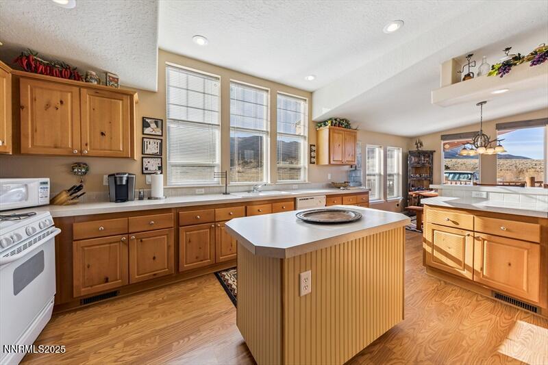 231 Atcheson Yerington, NV 89447 - Photo 13 of 30 a kitchen with stainless steel appliances granite countertop a stove a sink dishwasher and a refrigerator