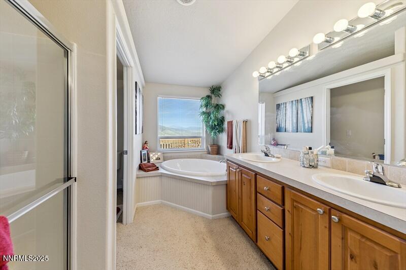 231 Atcheson Yerington, NV 89447 - Photo 18 of 30 a spacious bathroom with a tub double sink and mirror